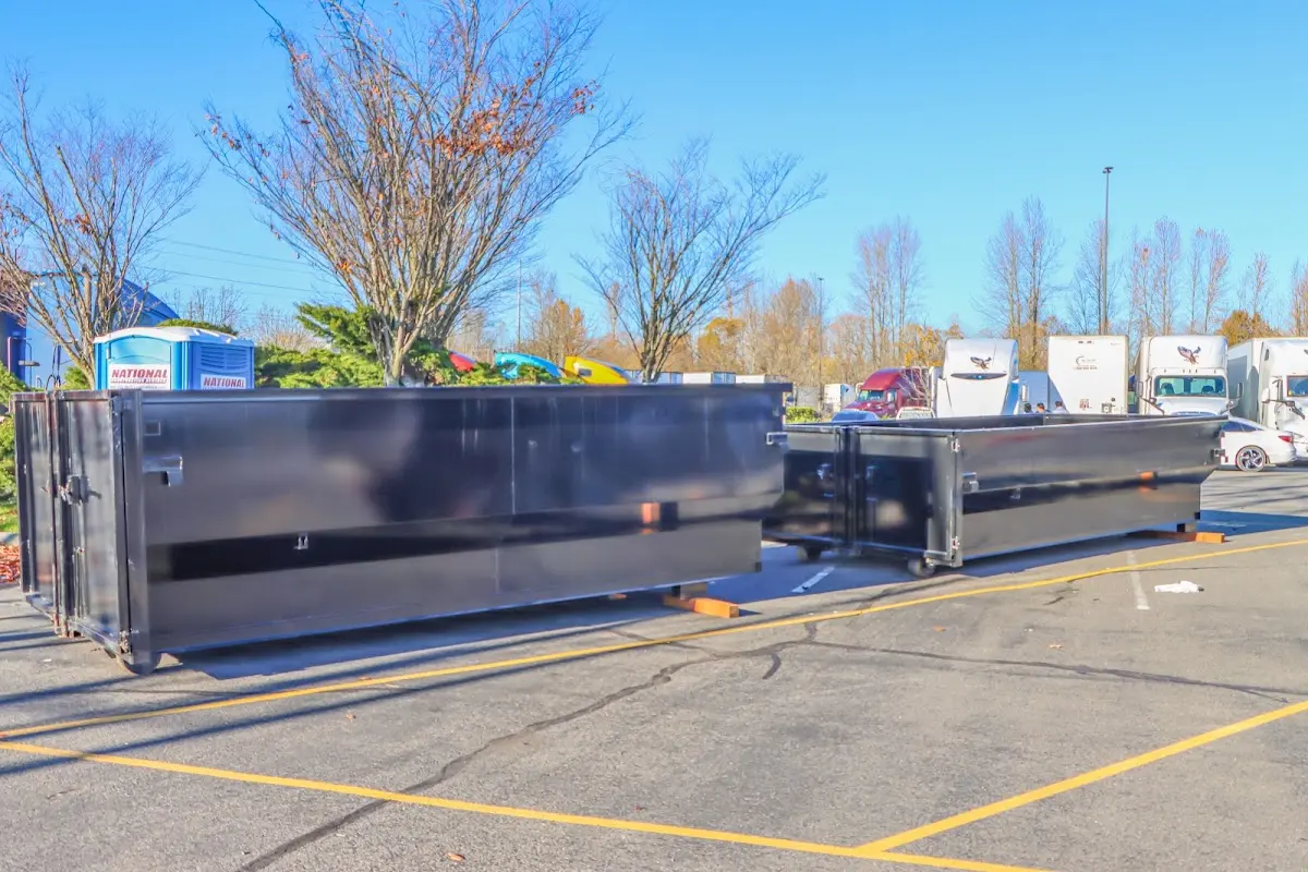 Professional dumpster rental service with roll-off container on residential driveway in Inkster